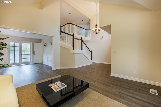 unfurnished living room with french doors, beam ceiling, high vaulted ceiling, and dark hardwood / wood-style floors