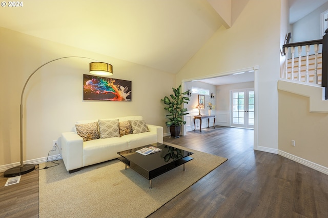 living room with visible vents, stairway, dark wood-type flooring, high vaulted ceiling, and baseboards