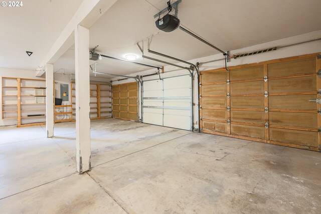 garage featuring a garage door opener and electric panel