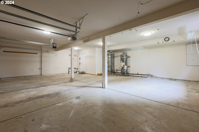 garage with water heater and a garage door opener