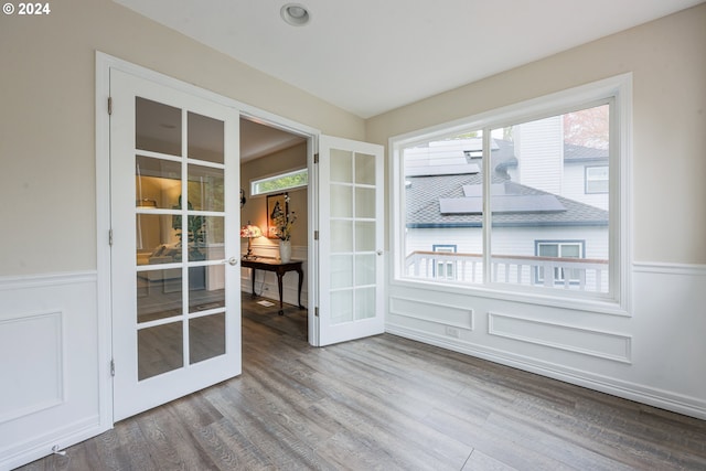 interior space with french doors and wood-type flooring