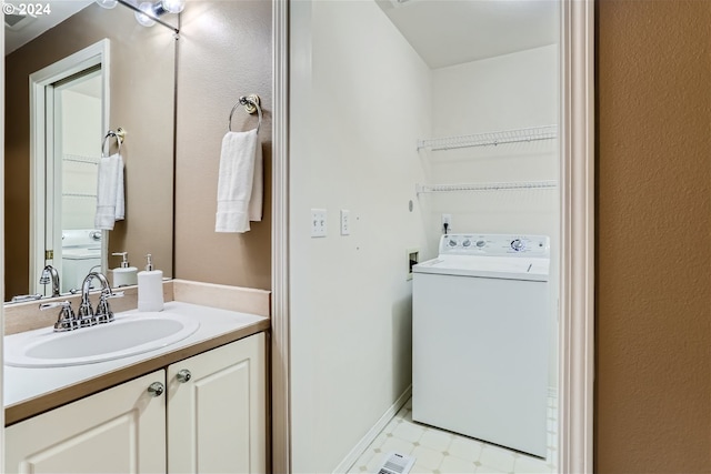 bathroom with washer / clothes dryer, vanity, and toilet