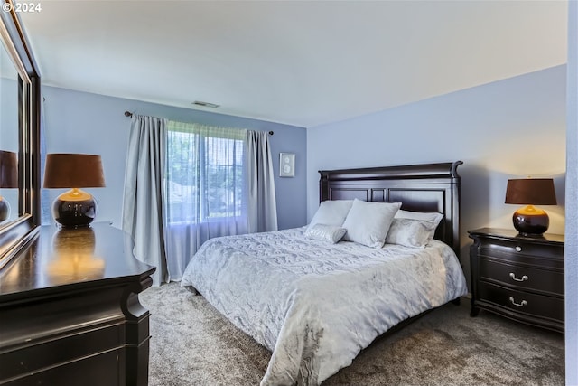 bedroom featuring dark colored carpet