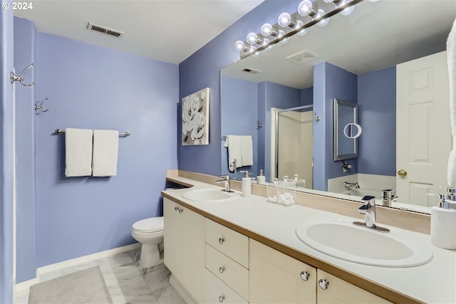 bathroom featuring vanity, a shower with shower door, and toilet