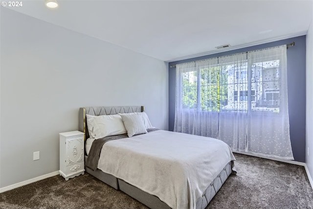 bedroom with dark colored carpet