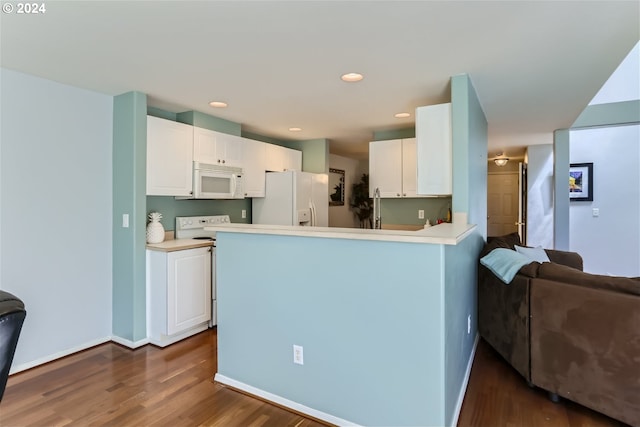 kitchen featuring white cabinets, dark hardwood / wood-style flooring, white appliances, and kitchen peninsula