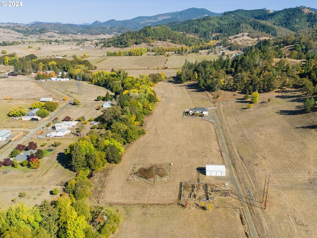 birds eye view of property with a mountain view and a rural view