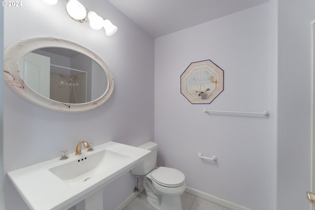 bathroom featuring walk in shower, sink, toilet, and tile patterned floors