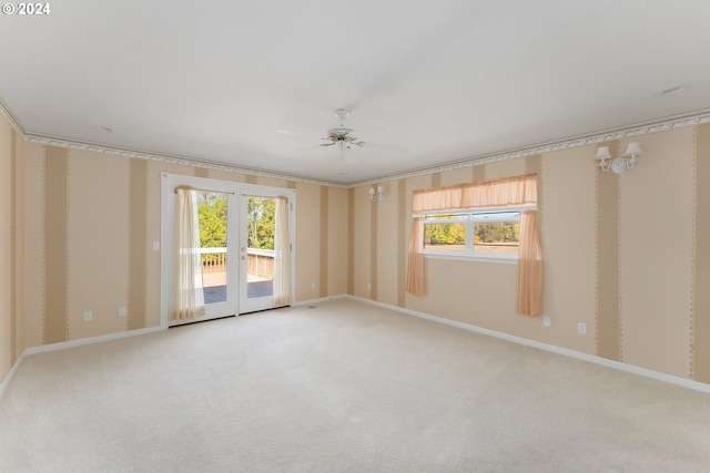 unfurnished room with a healthy amount of sunlight, ceiling fan, and carpet floors