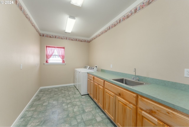 washroom with independent washer and dryer, sink, and cabinets