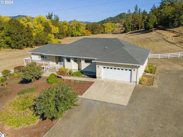 single story home with a garage and covered porch