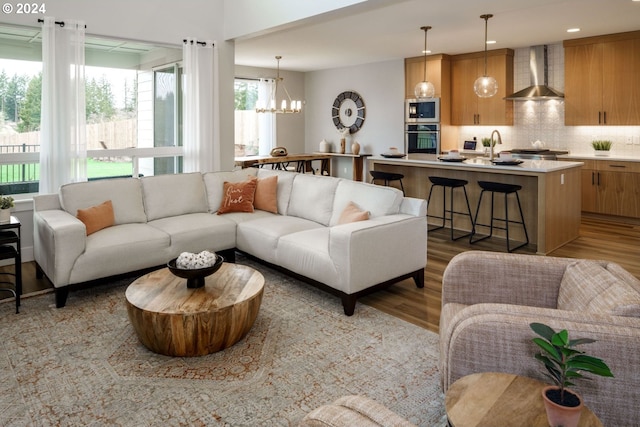 living area with recessed lighting, a notable chandelier, and wood finished floors