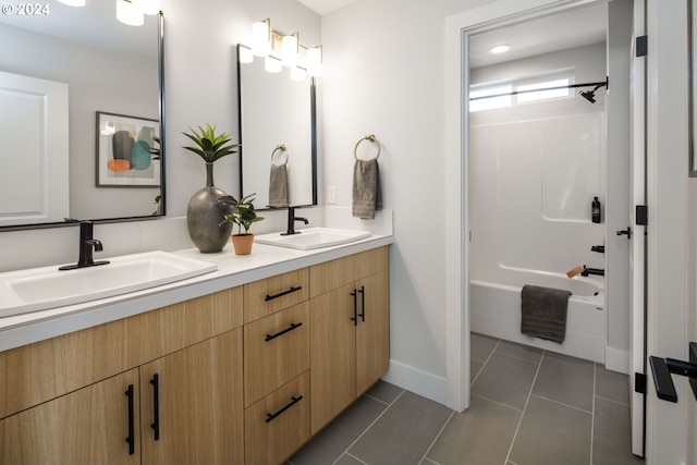 full bath with double vanity, shower / bath combination, tile patterned flooring, and a sink