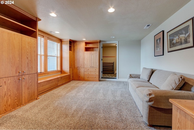 living room with light carpet and a textured ceiling