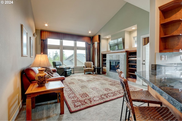 living room featuring carpet, high vaulted ceiling, and a tiled fireplace