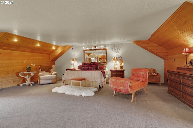 bedroom with a textured ceiling, light carpet, wood walls, and vaulted ceiling