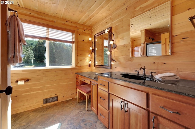 bathroom with vanity, walk in shower, wooden walls, and wood ceiling