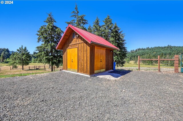 view of horse barn featuring a rural view