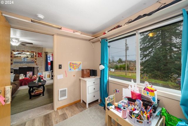 rec room featuring ceiling fan and wood finished floors