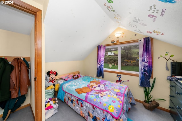 bedroom with lofted ceiling, carpet floors, and baseboards