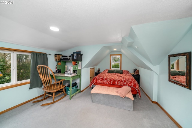 bedroom featuring lofted ceiling, baseboards, and carpet flooring