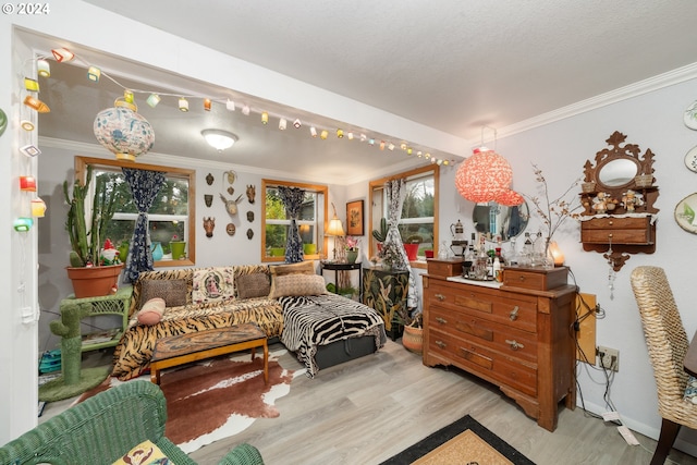 sitting room with ornamental molding and light wood finished floors