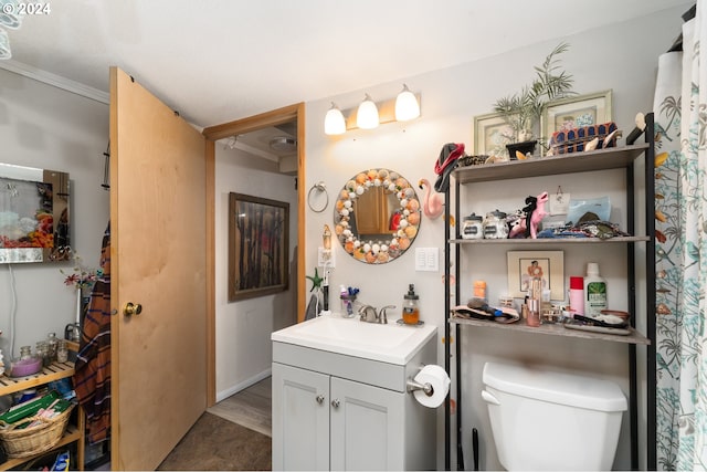 full bath with toilet, crown molding, and vanity