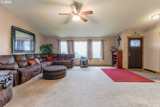 carpeted living room featuring ceiling fan