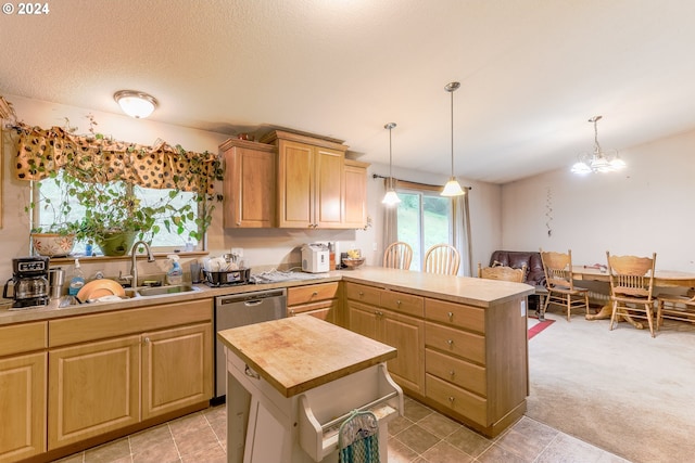 kitchen with a center island, an inviting chandelier, hanging light fixtures, dishwasher, and sink