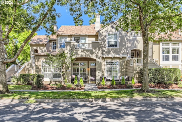 view of front of home with a balcony