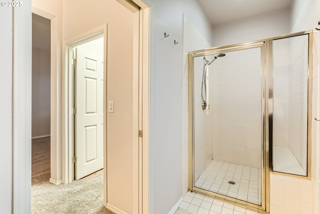 bathroom featuring a shower with door