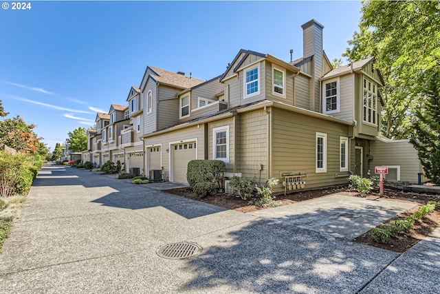 view of property exterior with central AC and a garage