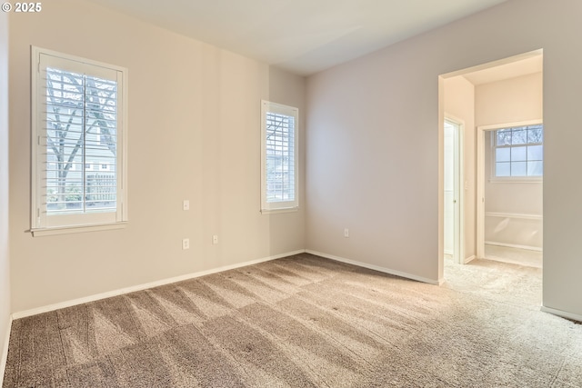 carpeted spare room featuring a healthy amount of sunlight