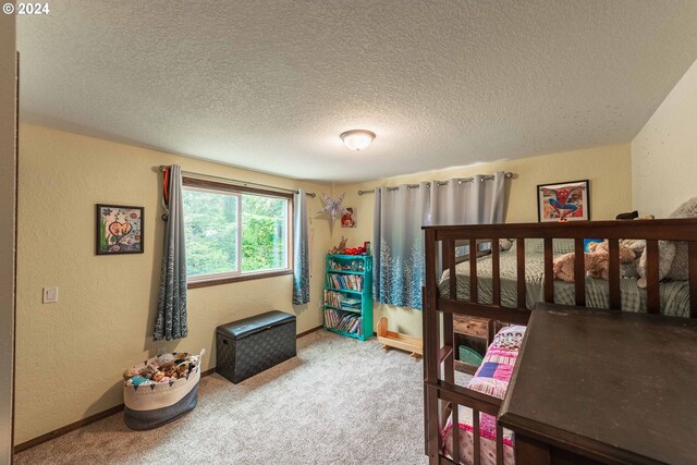 carpeted bedroom featuring a textured ceiling