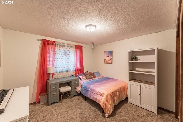 carpeted bedroom with a textured ceiling