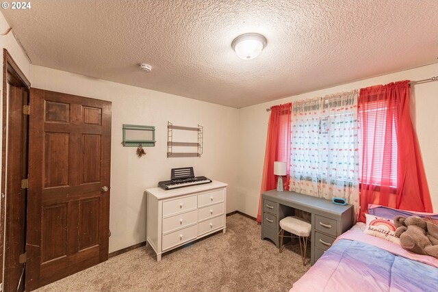 carpeted bedroom featuring a textured ceiling