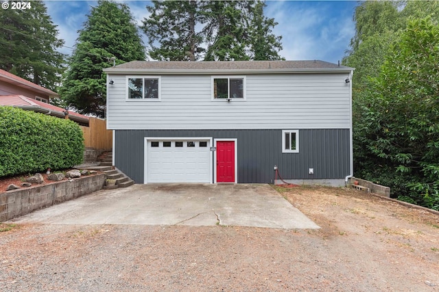 view of front of house featuring dirt driveway and a garage