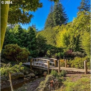 surrounding community featuring a deck with water view