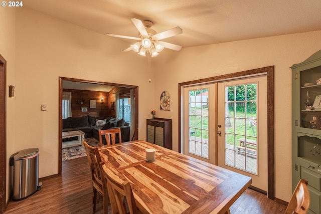 dining space featuring french doors, dark wood-type flooring, a ceiling fan, vaulted ceiling, and baseboards