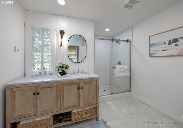 full bathroom featuring a shower stall, a sink, and visible vents