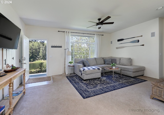 carpeted living area featuring a ceiling fan and visible vents
