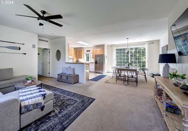 carpeted living room featuring ceiling fan