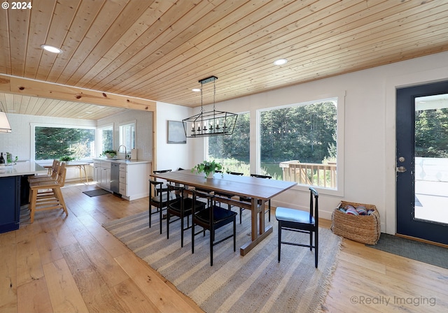 dining room with a notable chandelier, light wood-style flooring, wood ceiling, and beamed ceiling
