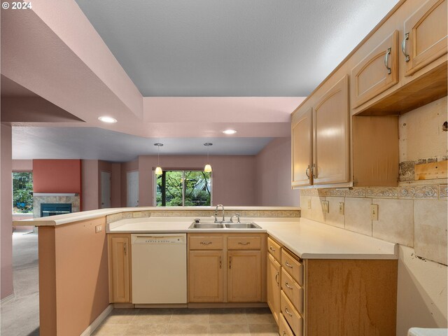 kitchen featuring light brown cabinets, sink, light tile patterned flooring, kitchen peninsula, and white dishwasher