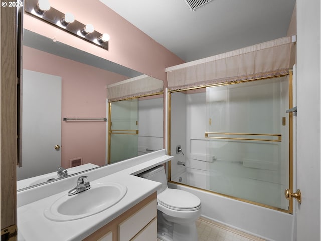 full bathroom featuring visible vents, toilet, vanity, shower / bath combination with glass door, and tile patterned floors