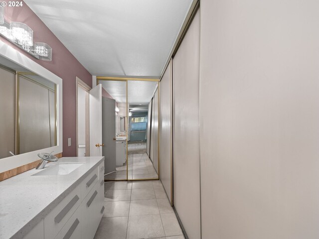 bathroom with vanity, toilet, and tile patterned floors