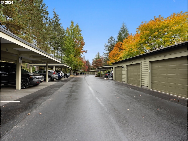 view of road featuring community garages