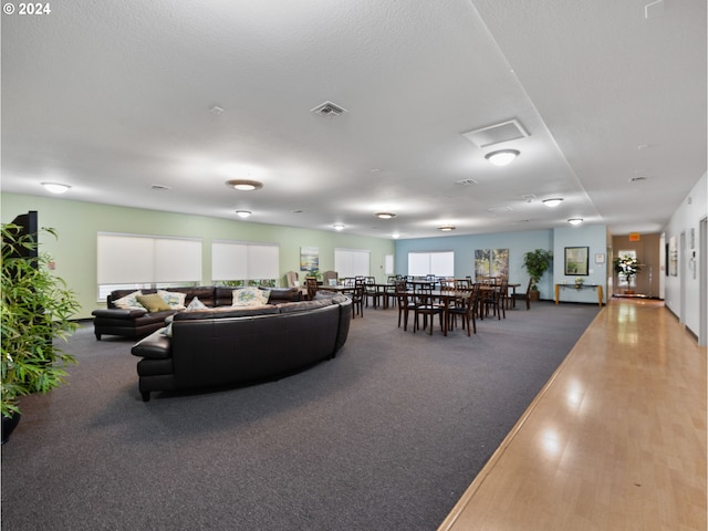 living room featuring carpet floors and a textured ceiling