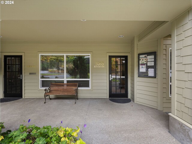 view of exterior entry featuring a patio