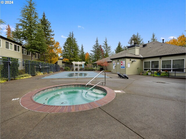 view of pool featuring a community hot tub and a patio area